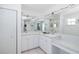 Bathroom with double vanity, large mirror, and ample storage at 8401 Carolyn Dr, Port Richey, FL 34668