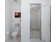 Bathroom with walk in shower featuring a glass door and tile surround at 8401 Carolyn Dr, Port Richey, FL 34668