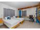 This bedroom is equipped with two twin beds, wooden accents, and an elongated desk area at 8401 Carolyn Dr, Port Richey, FL 34668
