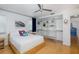 Bedroom features hardwood floors, bright windows, ceiling fan, and large, organized closet at 8401 Carolyn Dr, Port Richey, FL 34668