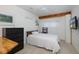 This bedroom features tile floors, a ceiling fan, and bright, natural light at 8401 Carolyn Dr, Port Richey, FL 34668