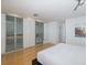 Bedroom features hardwood floors, ceiling fan, and closet with mirrored doors at 8401 Carolyn Dr, Port Richey, FL 34668