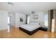 Spacious bedroom with hardwood floors and a modern design; adjacent bathroom entrance at 8401 Carolyn Dr, Port Richey, FL 34668