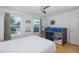 Bright bedroom featuring a bunk bed, a ceiling fan and natural light at 8401 Carolyn Dr, Port Richey, FL 34668