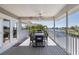 Covered deck overlooking the water features an outdoor kitchen and dining area for entertaining guests at 8401 Carolyn Dr, Port Richey, FL 34668