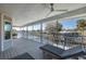 This covered outdoor deck has lounge chairs and a ceiling fan with views of the canal at 8401 Carolyn Dr, Port Richey, FL 34668