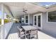 Spacious covered deck with outdoor seating, ceiling fans, and views of the surrounding neighborhood at 8401 Carolyn Dr, Port Richey, FL 34668