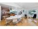 Open concept dining area showcasing a large white table with seating and a view of the outdoors at 8401 Carolyn Dr, Port Richey, FL 34668