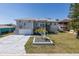 Beautiful two-story home featuring a basketball court, a well-manicured lawn and lovely front yard landscaping at 8401 Carolyn Dr, Port Richey, FL 34668