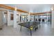 This large, open game room features recessed lighting and large sliding doors that open to the pool at 8401 Carolyn Dr, Port Richey, FL 34668