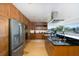 Modern kitchen boasts stainless steel appliances, dark countertops, and a view of lush greenery at 8401 Carolyn Dr, Port Richey, FL 34668