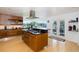 Stylish kitchen with a center island, stainless steel appliances, and backyard access at 8401 Carolyn Dr, Port Richey, FL 34668