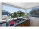 Kitchen sink with a view through a large window featuring palm trees and adjacent houses at 8401 Carolyn Dr, Port Richey, FL 34668