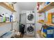 Functional laundry room with stacked washer and dryer, and ample shelving for storage at 8401 Carolyn Dr, Port Richey, FL 34668