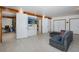 This large, open living room features tiled floors, a couch, recessed lighting and multiple closets at 8401 Carolyn Dr, Port Richey, FL 34668