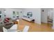 Bright living room featuring hardwood floors, recessed lighting, and contemporary decor with access to a covered porch at 8401 Carolyn Dr, Port Richey, FL 34668