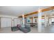 Spacious living area with exposed beams, ample lighting, and ping pong table at 8401 Carolyn Dr, Port Richey, FL 34668
