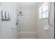 Shower features multiple shower heads, built in seating and tiled surround at 8401 Carolyn Dr, Port Richey, FL 34668