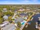Expansive aerial view of a waterfront home with a pool, dock, and easy access to the open bay at 8408 Damen Ln, Port Richey, FL 34668