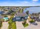 Aerial view of waterfront homes with docks, lush landscaping, and a sparkling blue waterway at 8408 Damen Ln, Port Richey, FL 34668