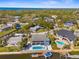 Stunning aerial view of waterfront home with a private pool and boat dock and easy access to the open bay at 8408 Damen Ln, Port Richey, FL 34668