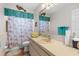 Bathroom featuring modern fixtures, neutral colors, and a shower/tub combo at 8408 Damen Ln, Port Richey, FL 34668