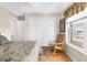 Bedroom features new windows, a rocking chair, and a spacious closet at 8408 Damen Ln, Port Richey, FL 34668
