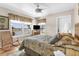 Bright bedroom with water views, wicker rocking chair, and ceiling fan at 8408 Damen Ln, Port Richey, FL 34668
