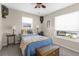 Cozy bedroom with bright windows, ceiling fan, and charming decor at 8408 Damen Ln, Port Richey, FL 34668