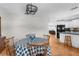 Bright dining room with table set and an open view to a kitchen with modern appliances at 8408 Damen Ln, Port Richey, FL 34668