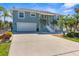 Two-story home with a spacious driveway, two car garage, and beautiful landscaping at 8408 Damen Ln, Port Richey, FL 34668