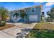 Charming home with two-car garage, white stairs leading to the entrance, and lush green lawn at 8408 Damen Ln, Port Richey, FL 34668