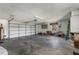 Spacious two car garage with white walls and ample room for storage and vehicles at 8408 Damen Ln, Port Richey, FL 34668
