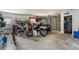 Cluttered two car garage with an array of bicycles, power tools, and equipment at 8408 Damen Ln, Port Richey, FL 34668