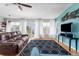 Bright living room with water views, hard wood floors, ceiling fan, and modern furnishings at 8408 Damen Ln, Port Richey, FL 34668