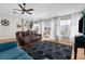 Bright living room with water views, hard wood floors, ceiling fan, and modern furnishings at 8408 Damen Ln, Port Richey, FL 34668