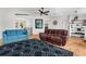 Open-concept living room featuring neutral walls, wood floors, and modern furnishings at 8408 Damen Ln, Port Richey, FL 34668