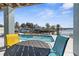 Charming covered patio overlooking a refreshing waterfront pool and scenic water views, ideal for outdoor dining at 8408 Damen Ln, Port Richey, FL 34668