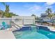 Inviting pool and spa with waterfront views and ample seating, perfect for outdoor relaxation and entertaining at 8408 Damen Ln, Port Richey, FL 34668