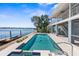 The waterfront pool offers a refreshing escape with stunning water views, seamlessly blending indoor and outdoor living at 8408 Damen Ln, Port Richey, FL 34668