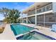 Beautiful waterfront home featuring a private pool, outdoor seating, and a dock for boating enthusiasts at 8408 Damen Ln, Port Richey, FL 34668