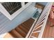 Outdoor staircase descends to an outdoor patio with a decorative rug and colorful furniture at 8408 Damen Ln, Port Richey, FL 34668