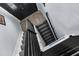 Modern staircase with carpeted steps and black metal railings, leading to a stylish entryway at 8408 Damen Ln, Port Richey, FL 34668