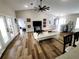 Spacious living room with wood-look flooring, a fan, and doorways leading to other rooms of the house at 9089 Dupont Ave, Spring Hill, FL 34608