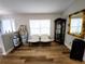 Sunlit sitting room with hardwood floors, complemented by elegant vases, display cabinet, and comfortable seating at 9089 Dupont Ave, Spring Hill, FL 34608