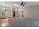 Bright living room with hardwood floors, neutral walls, and large arched windows for natural light at 9273 Brady St, Spring Hill, FL 34608