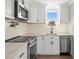 Close up of Updated kitchen featuring stainless appliances, countertops, and modern cabinetry at 9384 Midway St, Spring Hill, FL 34608