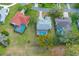 Aerial view of the home showcasing a screened lanai, pool, and well-maintained landscaping at 9397 Merriweather Dr, Weeki Wachee, FL 34613