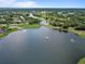 Scenic aerial view of lakefront homes, golf course, and lush landscaping at 9397 Merriweather Dr, Weeki Wachee, FL 34613