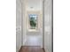 Bright bathroom with a soaking tub and natural light, framed by a hallway entrance at 9397 Merriweather Dr, Weeki Wachee, FL 34613